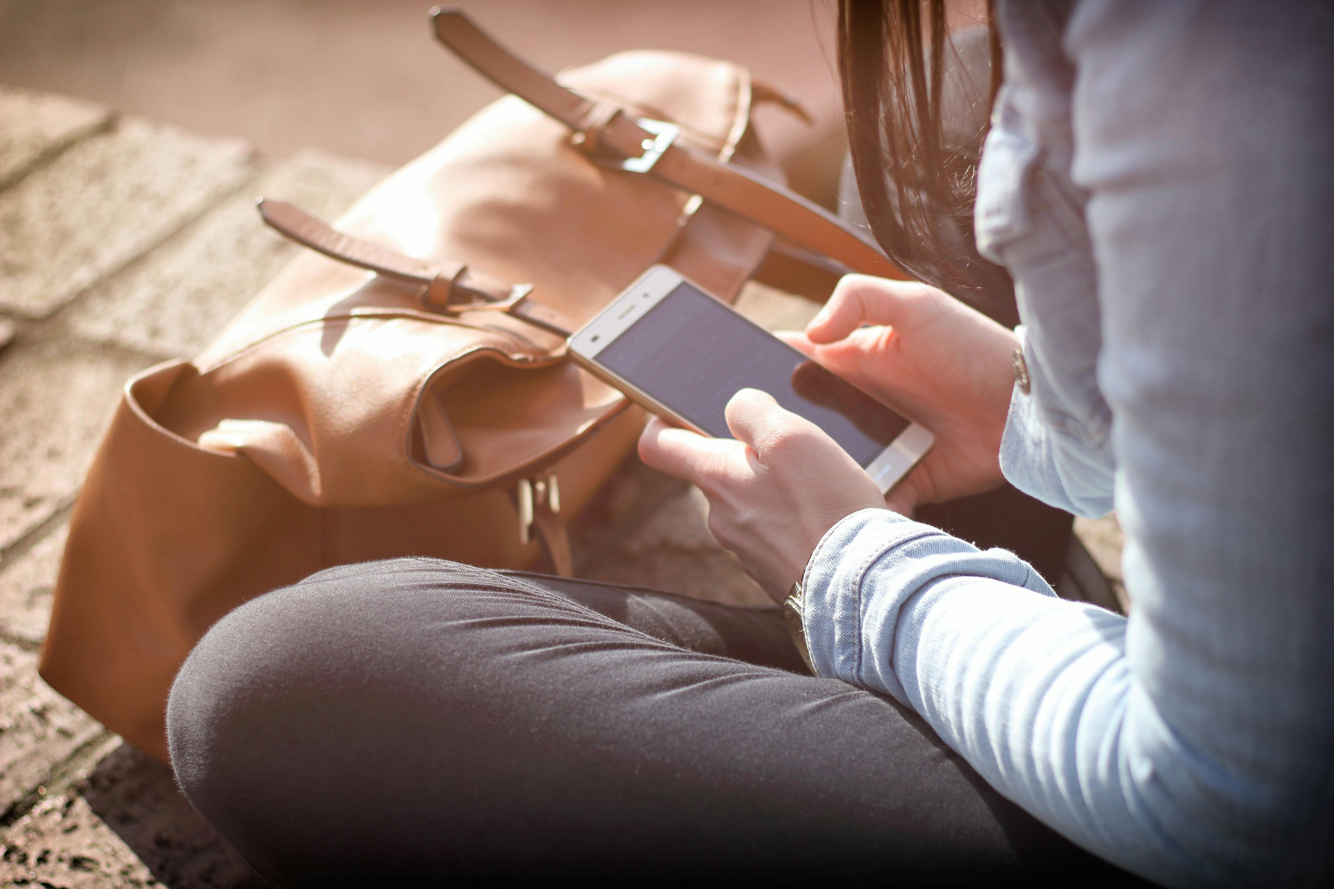 student with smartphone