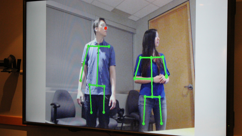 Screen with people and green lines