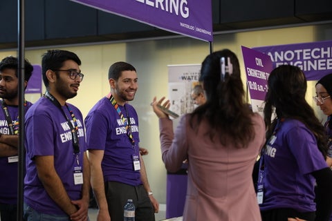 People talking at information booth