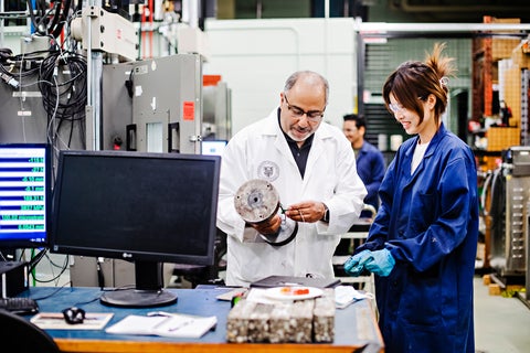 Man and woman looking at concrete samples in a lab