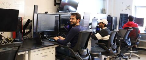 Grad students coding and working on computers