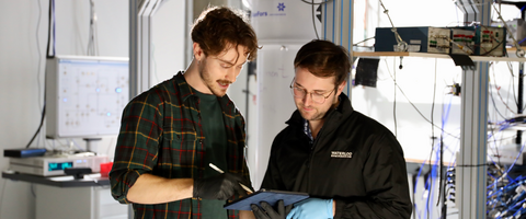 Two Engineering Grad Students working together in a lab