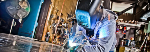 Student welding in a lab