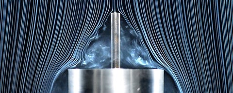 A photo of two cylinders in a wind tunnel in a study on drag.