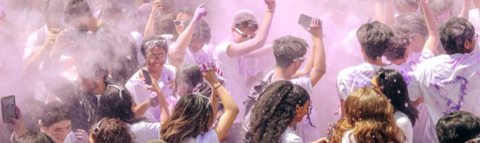 Student celebrating in purple smoke