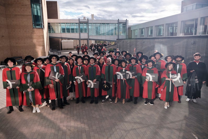 A large group shot of graduates outside
