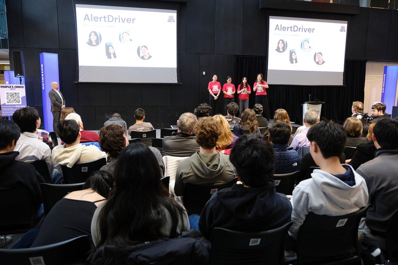 Group of students presenting in a pitch competition