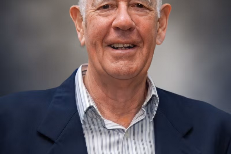 A man smiles at the camera.