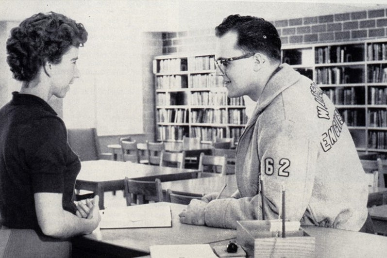 University of Waterloo librarian speaking to an engineering student in jacket.