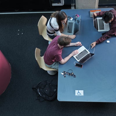 Group of students working on laptops