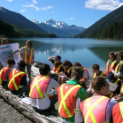 Professor talking to group of students outside