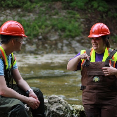 Students talking in river
