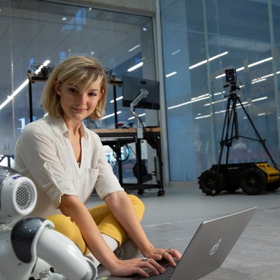 Student programming a robot