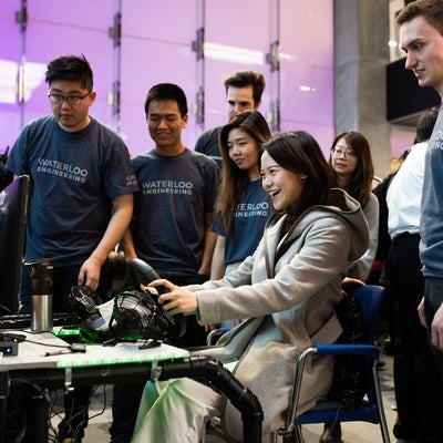 Students gathered around a gaming system