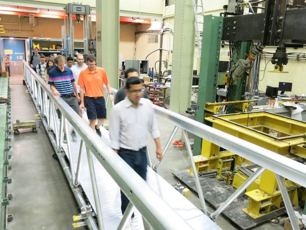 Indoor 70ft pedestrian bridge with people walking across