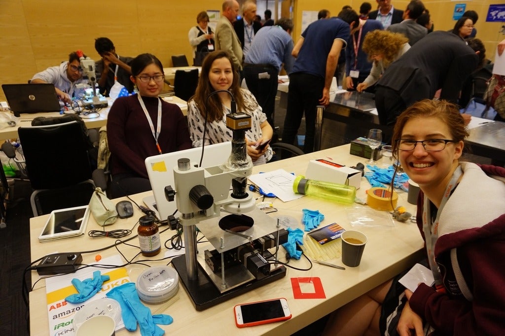 members of the university of waterloo nanorobotics group sitting around a table