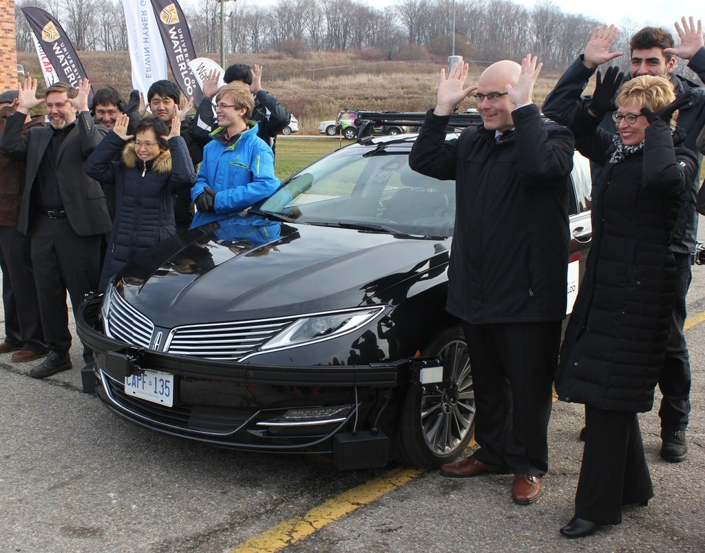 Dignitaries mug for the camera at announcement about testing program for automated vehicles.