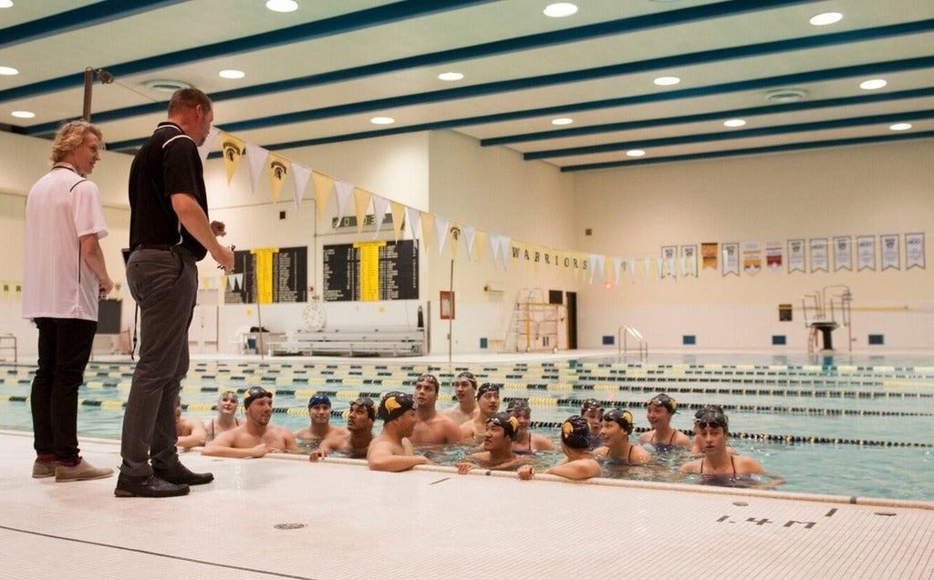 Coach Jeff Slater instructs members of the University of Waterloo swim team.
