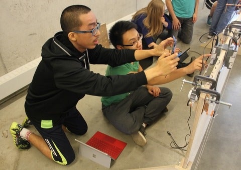 Ken Jen Lee and Eric Chee work on their Lego plotter.