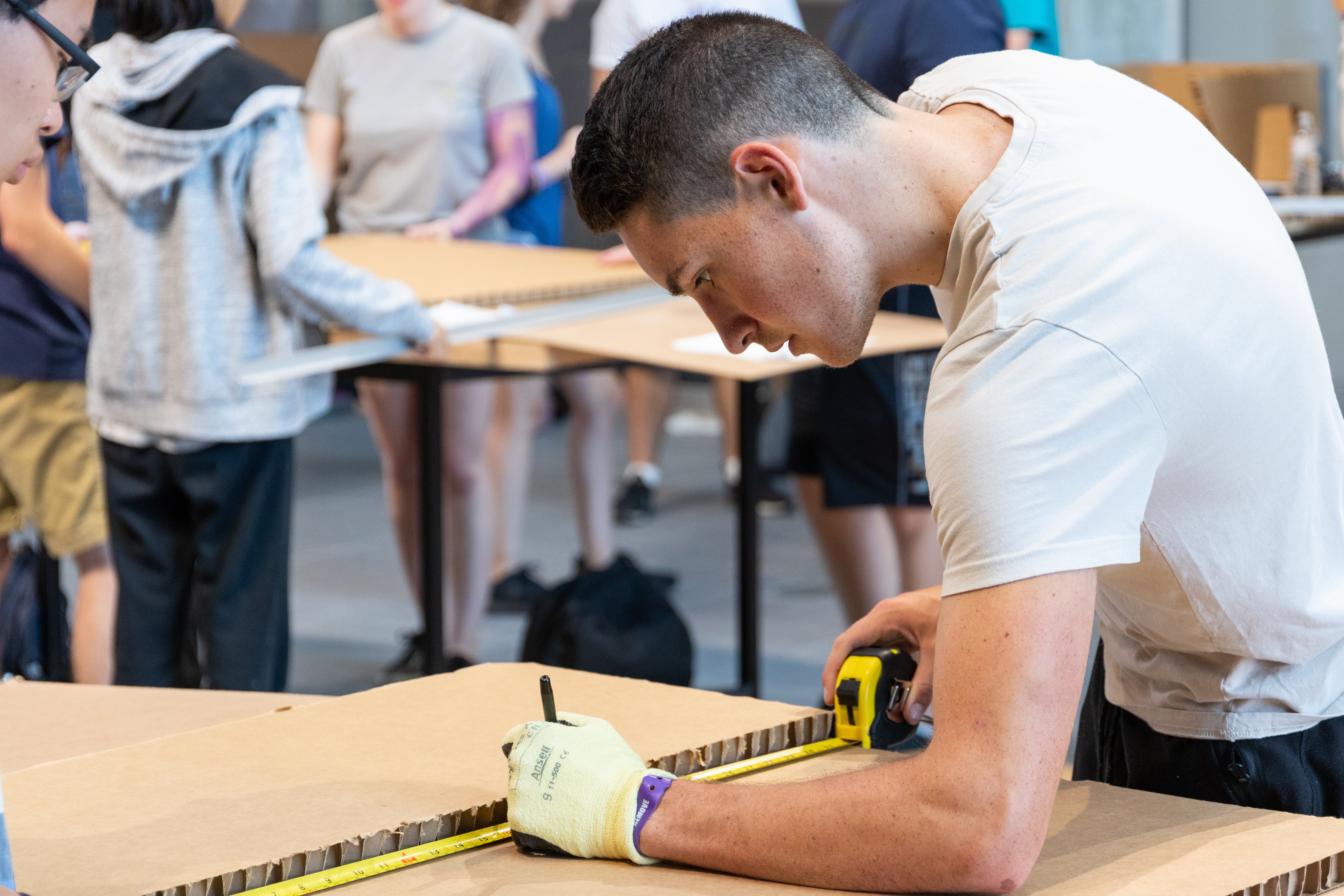 Student measuring supplies for project