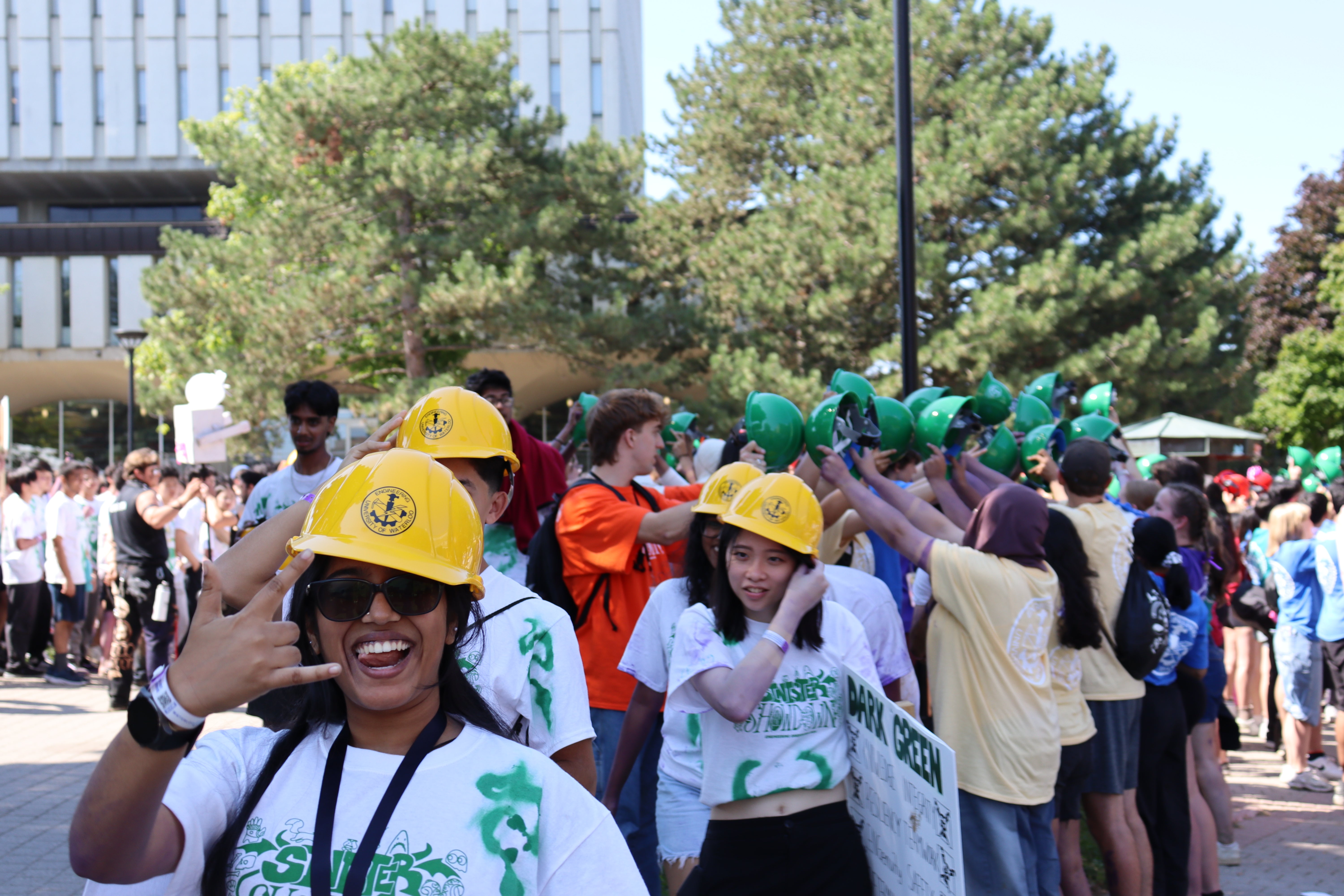 Students receiving their yellow hard hats at orientation