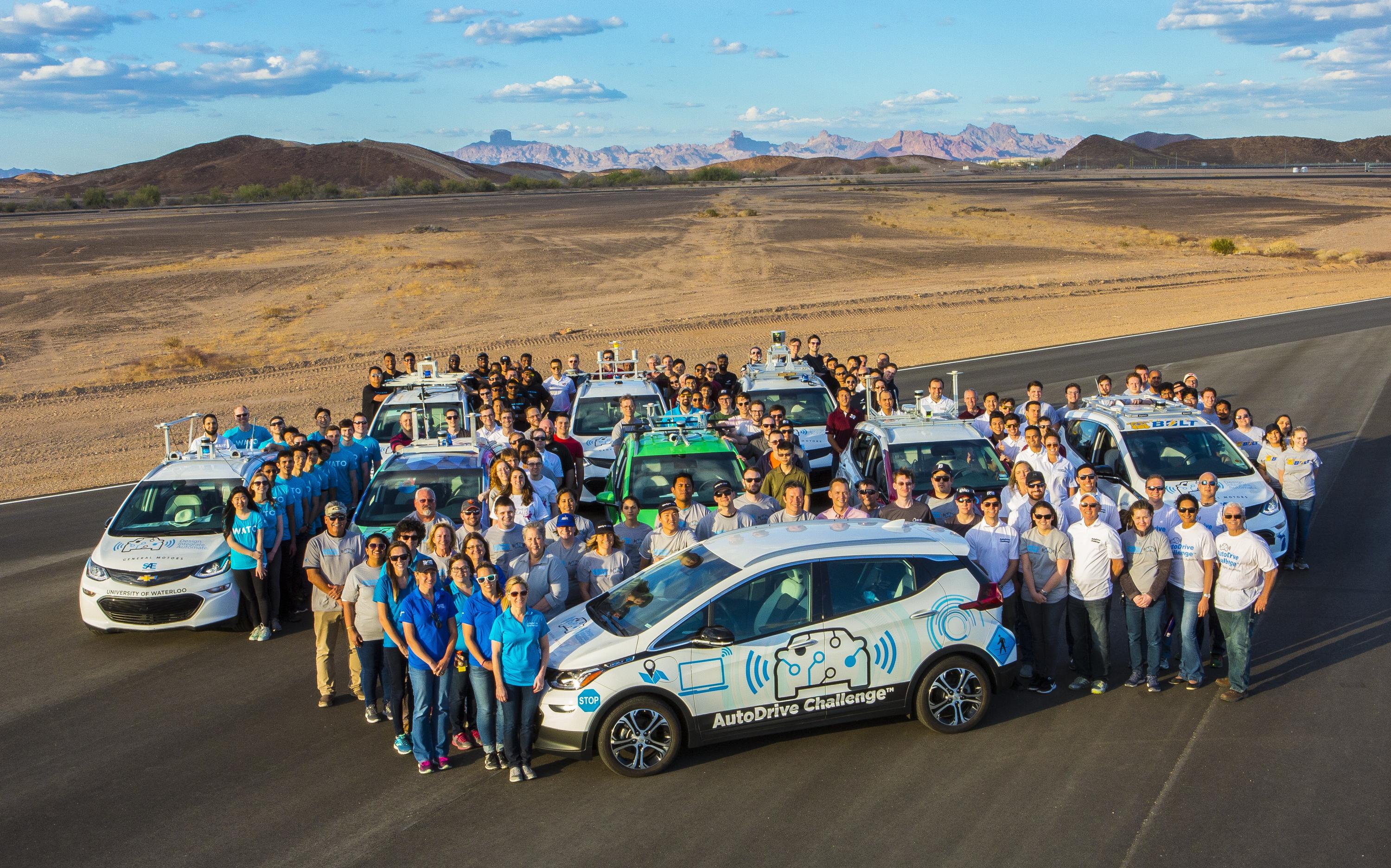Teams pose for a group group at the AutoDrive Challenge in Arizona.