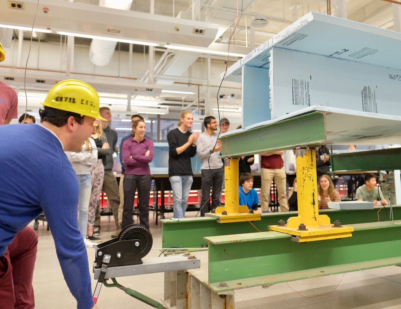 Civil engineering students test bridges made out of styrofoam during an event in the Engineering Ideas Clinic in the new Engineering 7 building.