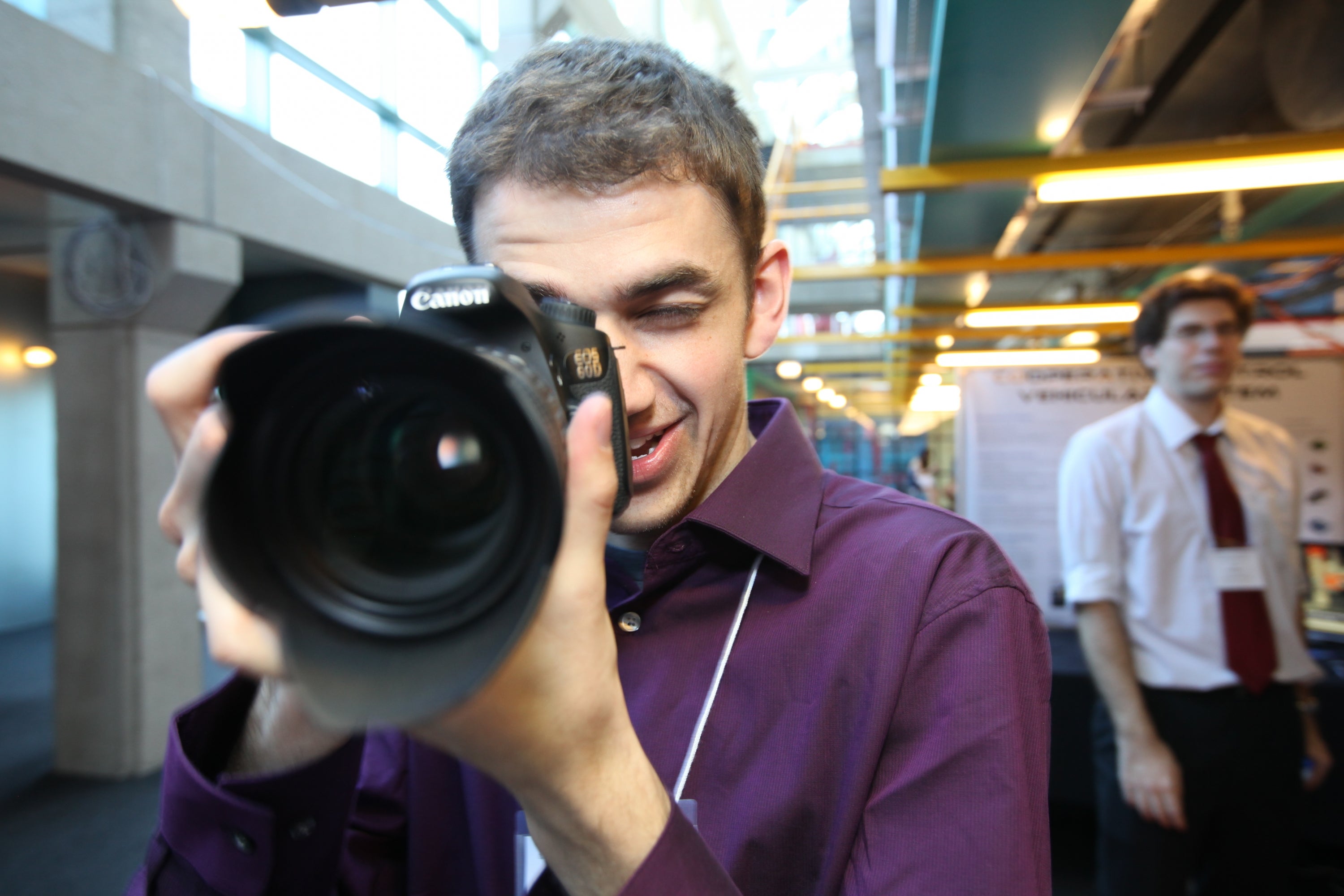Man looking through camera lens
