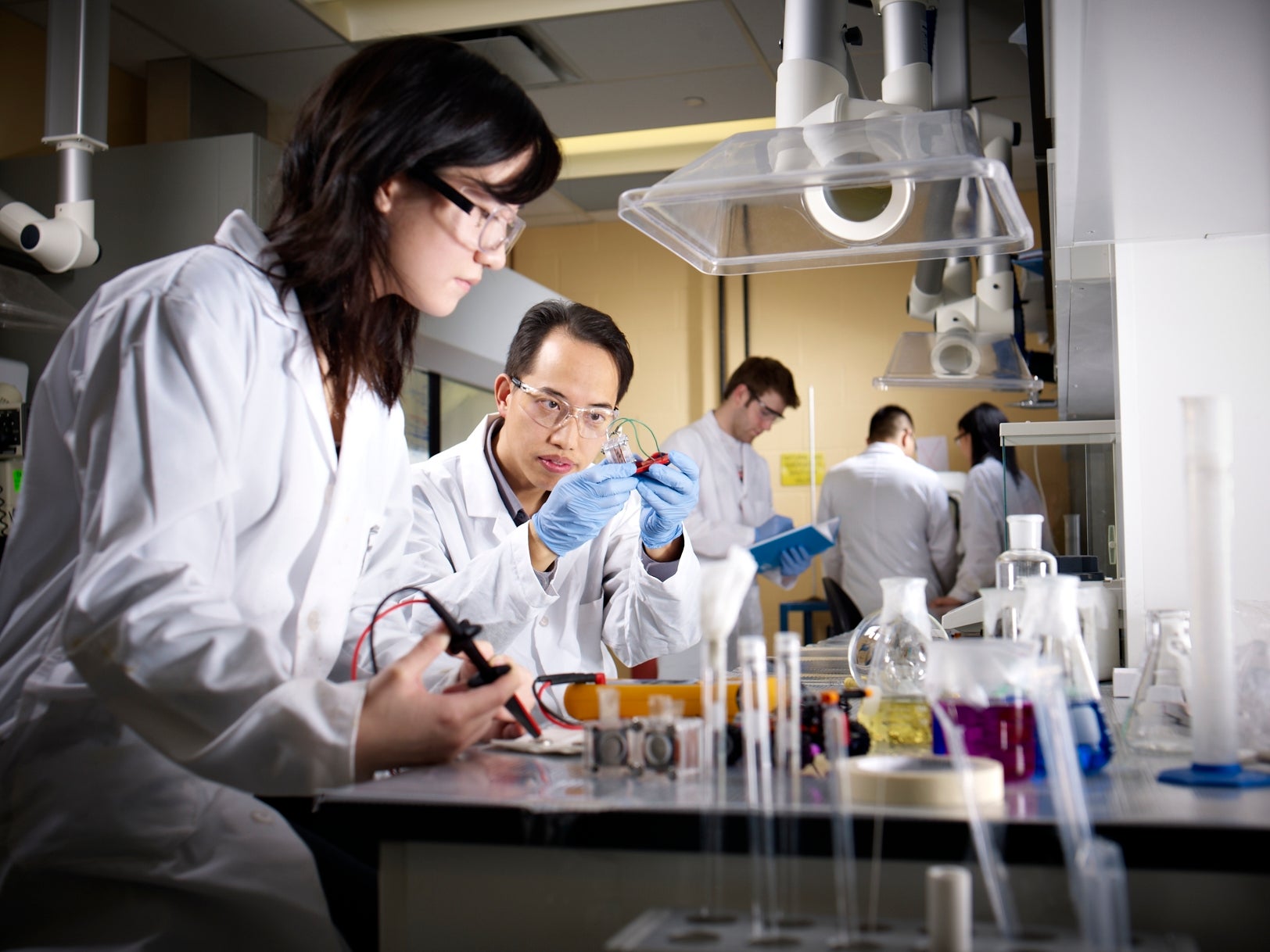 students and professor working in a chemical engineering lab