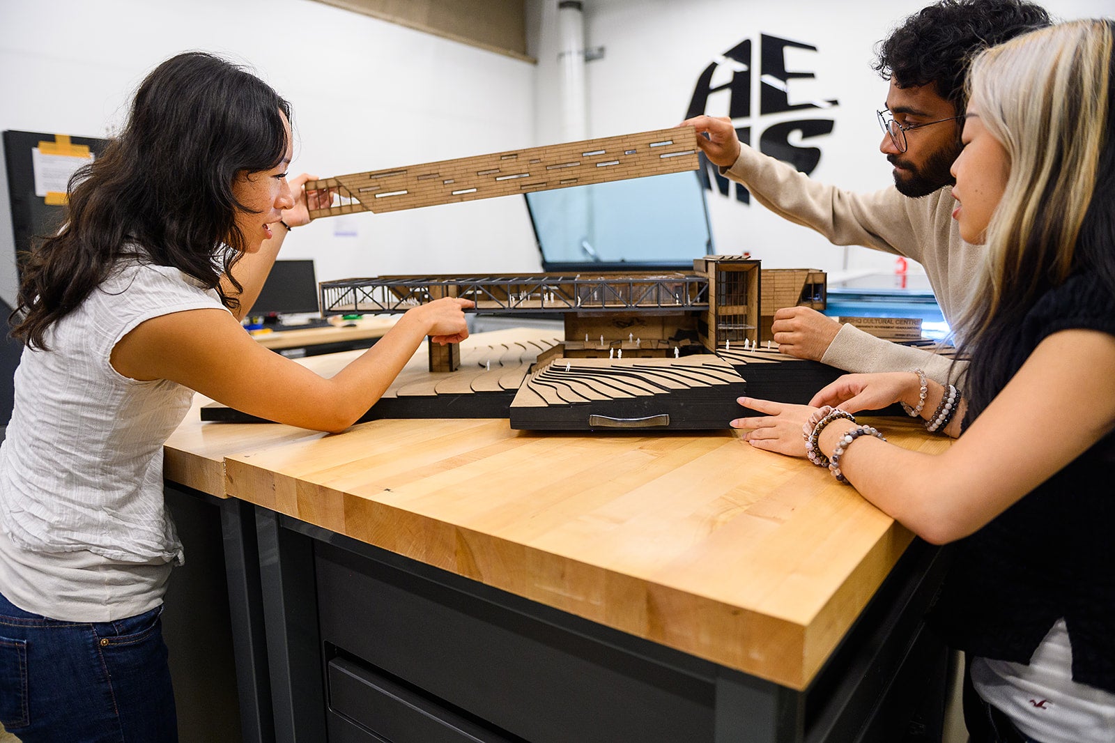 Students looking at model in AE makerspace