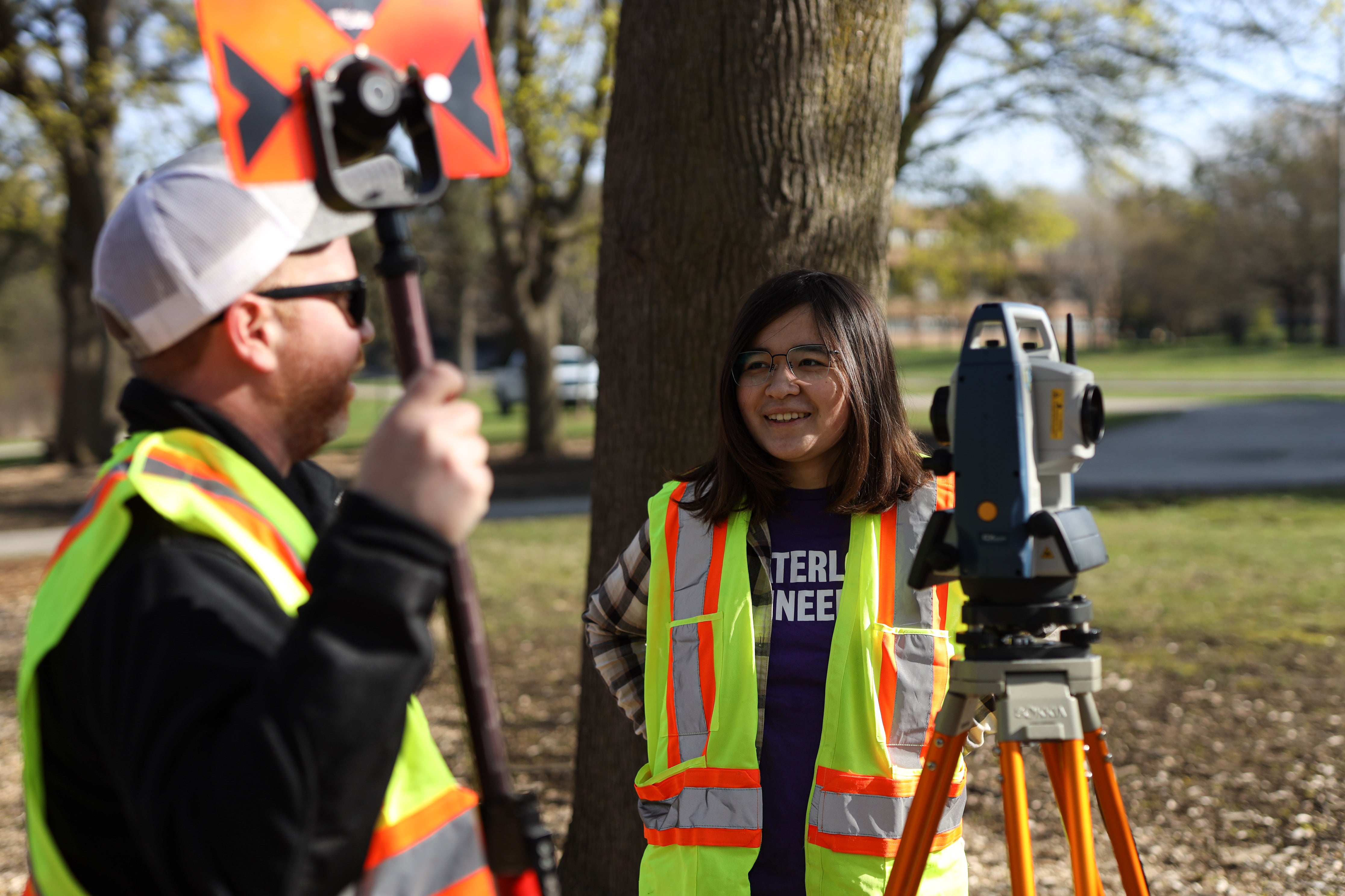 Student conducting surveying work outside