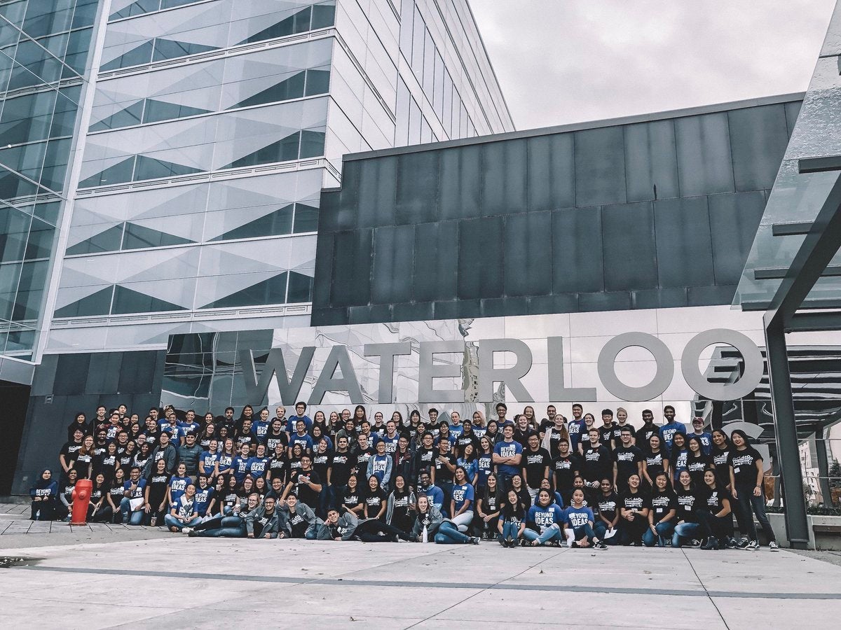 Students in front of Engineering 7 sign