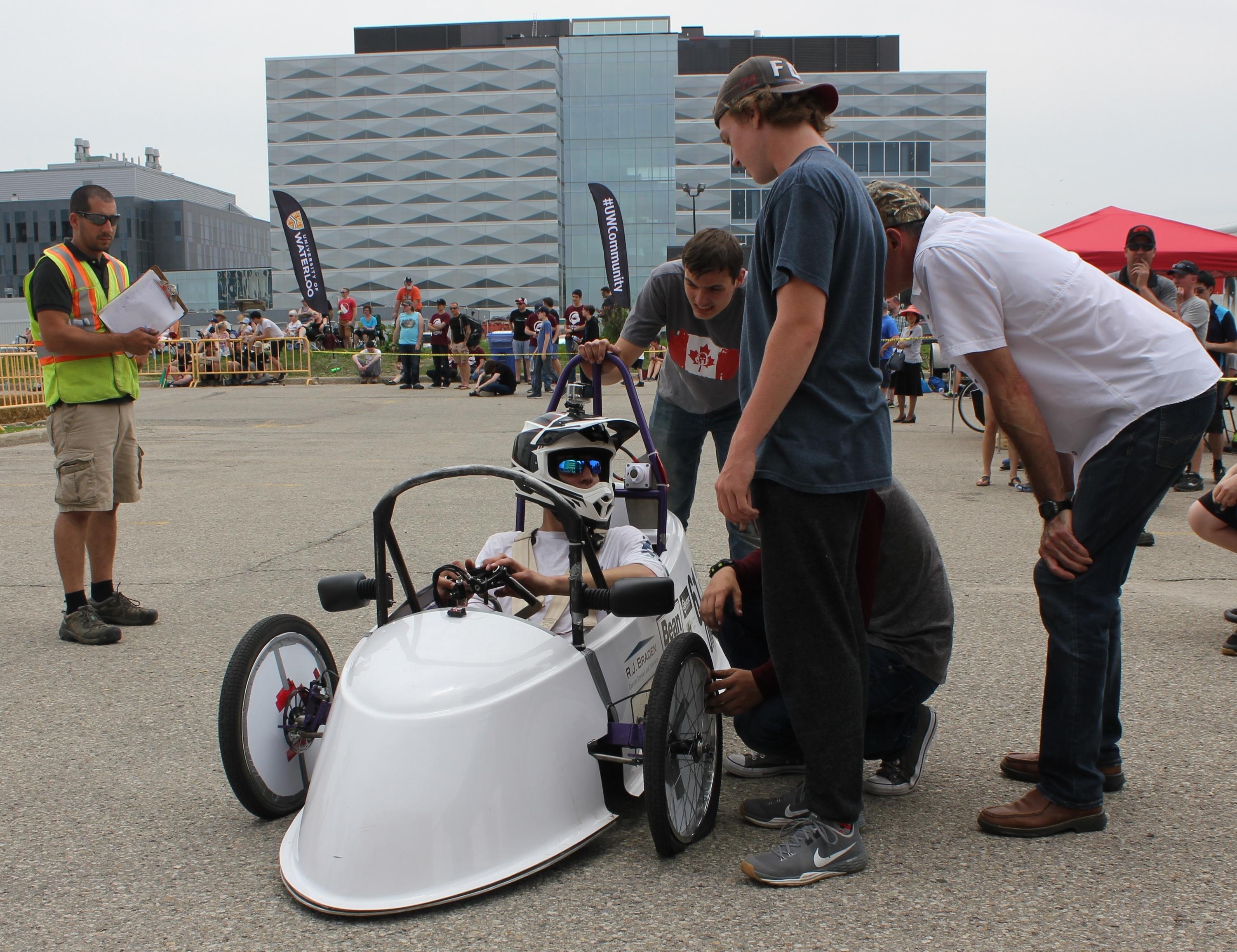 The driver for a team from the Ottawa area pulls into the pits at the Waterloo Electric Vehicle Challenge on Saturday with a flat tire.