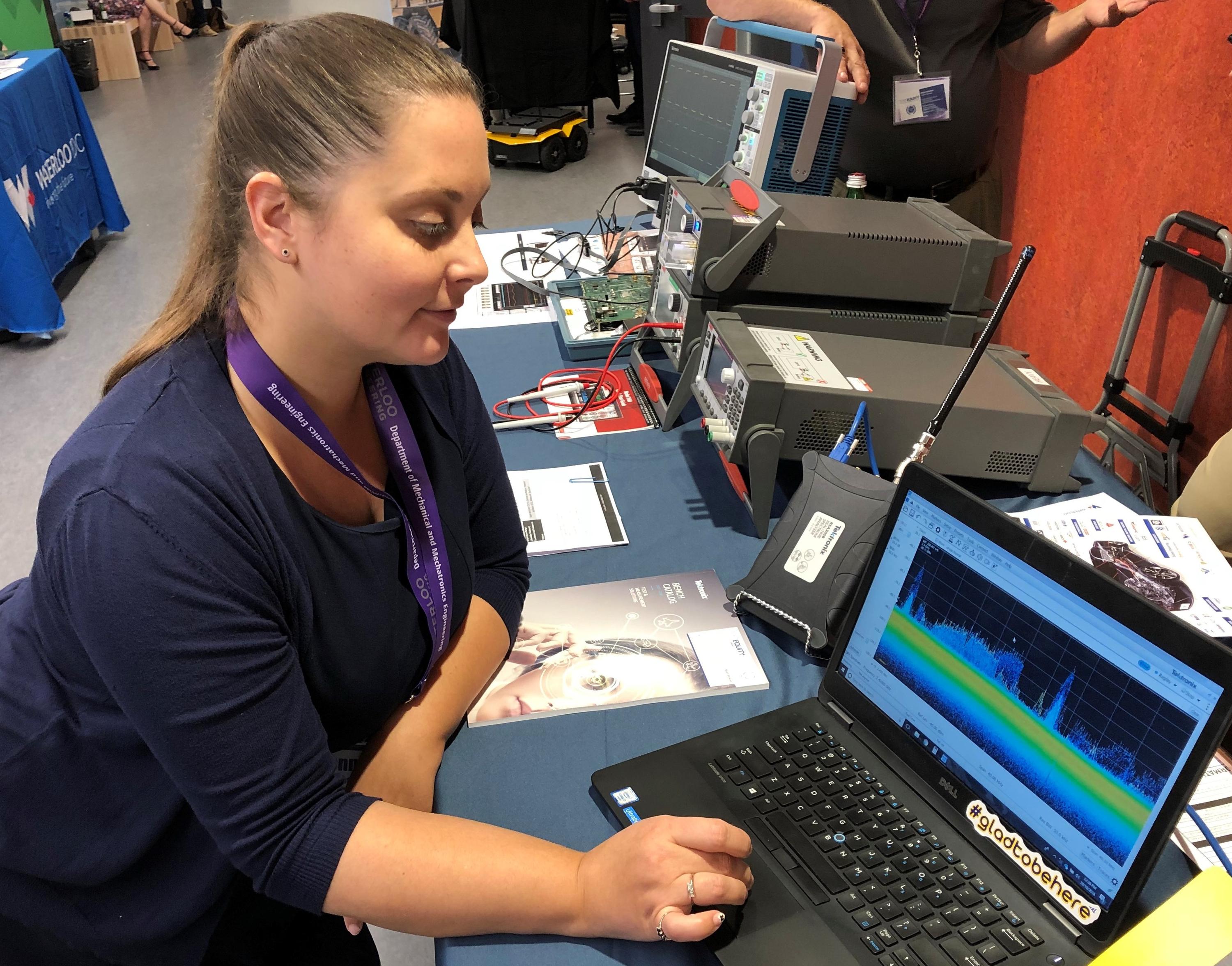 Jennifer Biesinger of Tektronix, one of the industry exhibitors at the 2018 AutoTech Symposium, displays a real-time representation of electronic interference at the one-day event.