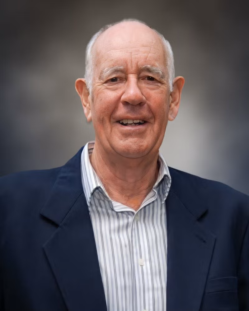 A man smiles at the camera.