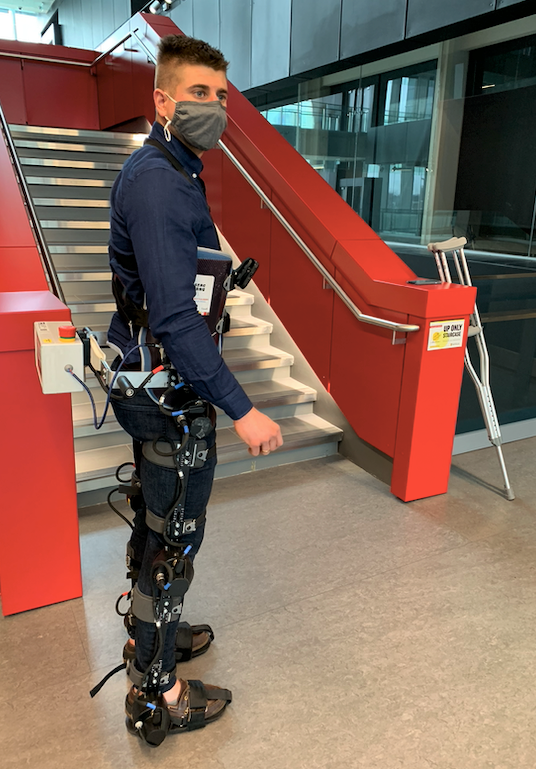 PhD candidate Brokoslaw Laschowski wears an exoskeleton during testing in Engineering 7.