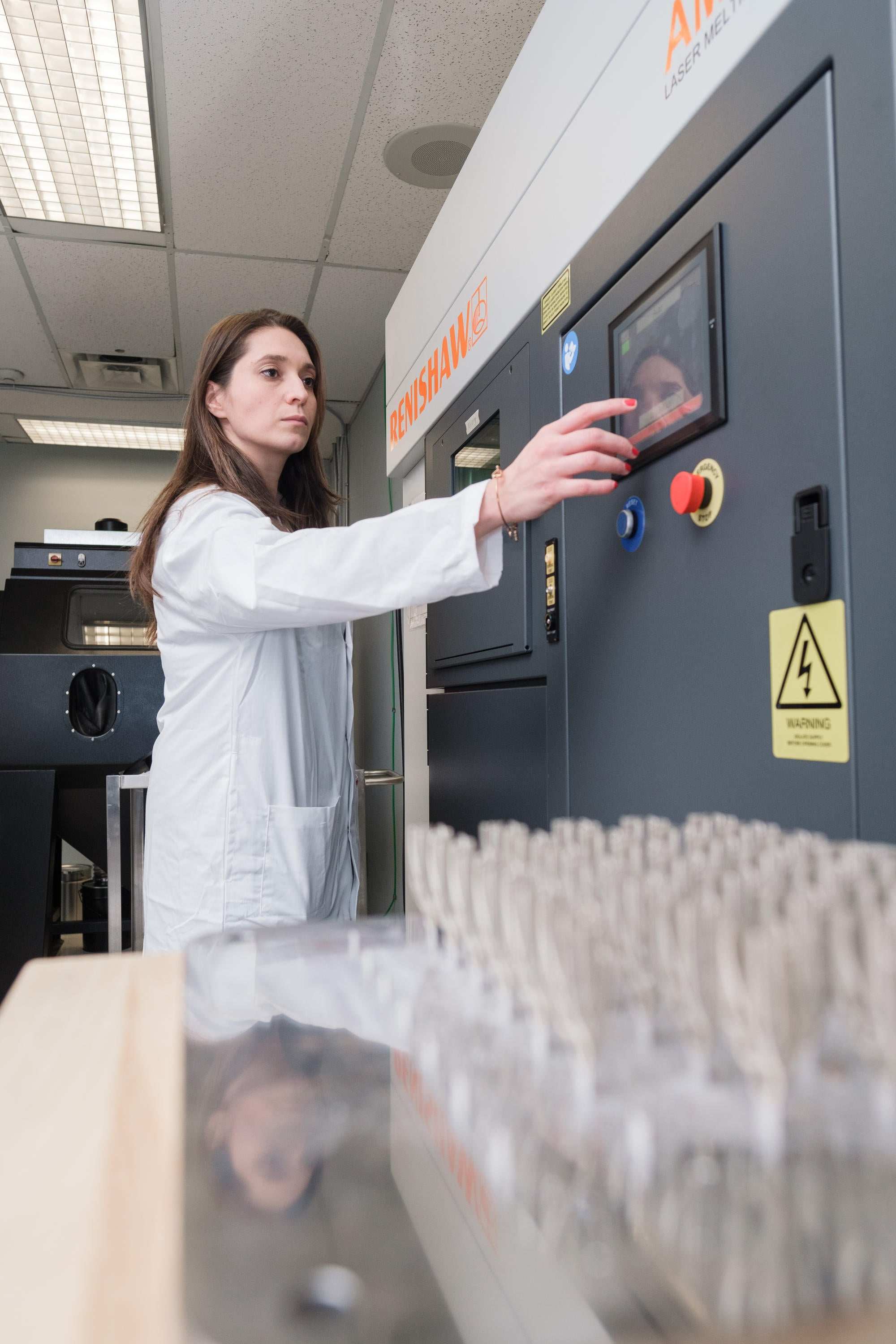 PhD student using 3d printer