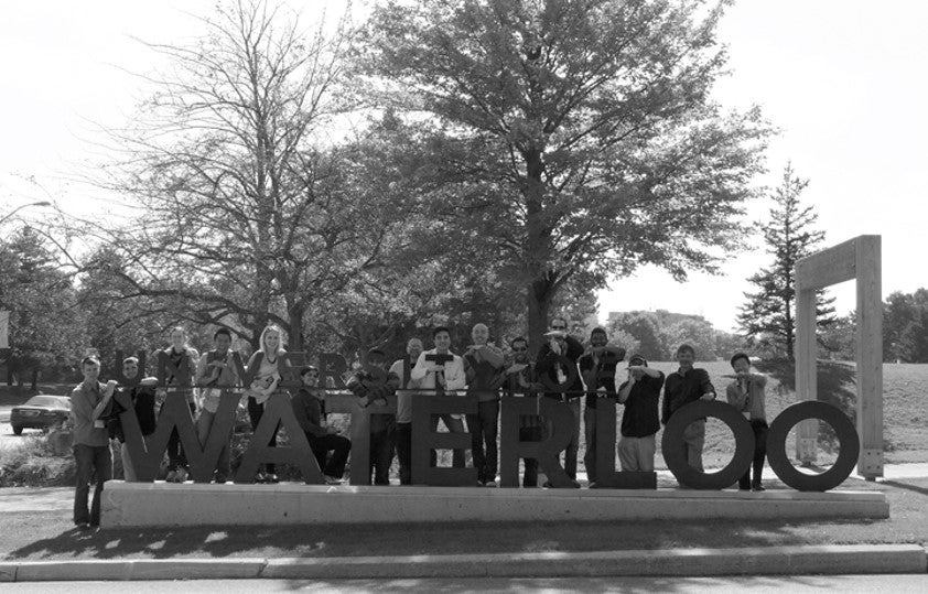 A group of engineering alumni with the Waterloo sign.