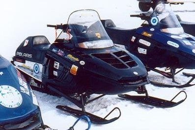 Snowmobile lined up in the snow
