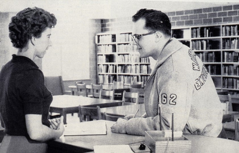 University of Waterloo librarian speaking to an engineering student in jacket.