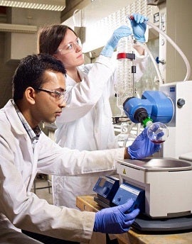 Graduate students conducting an experiment in a lab