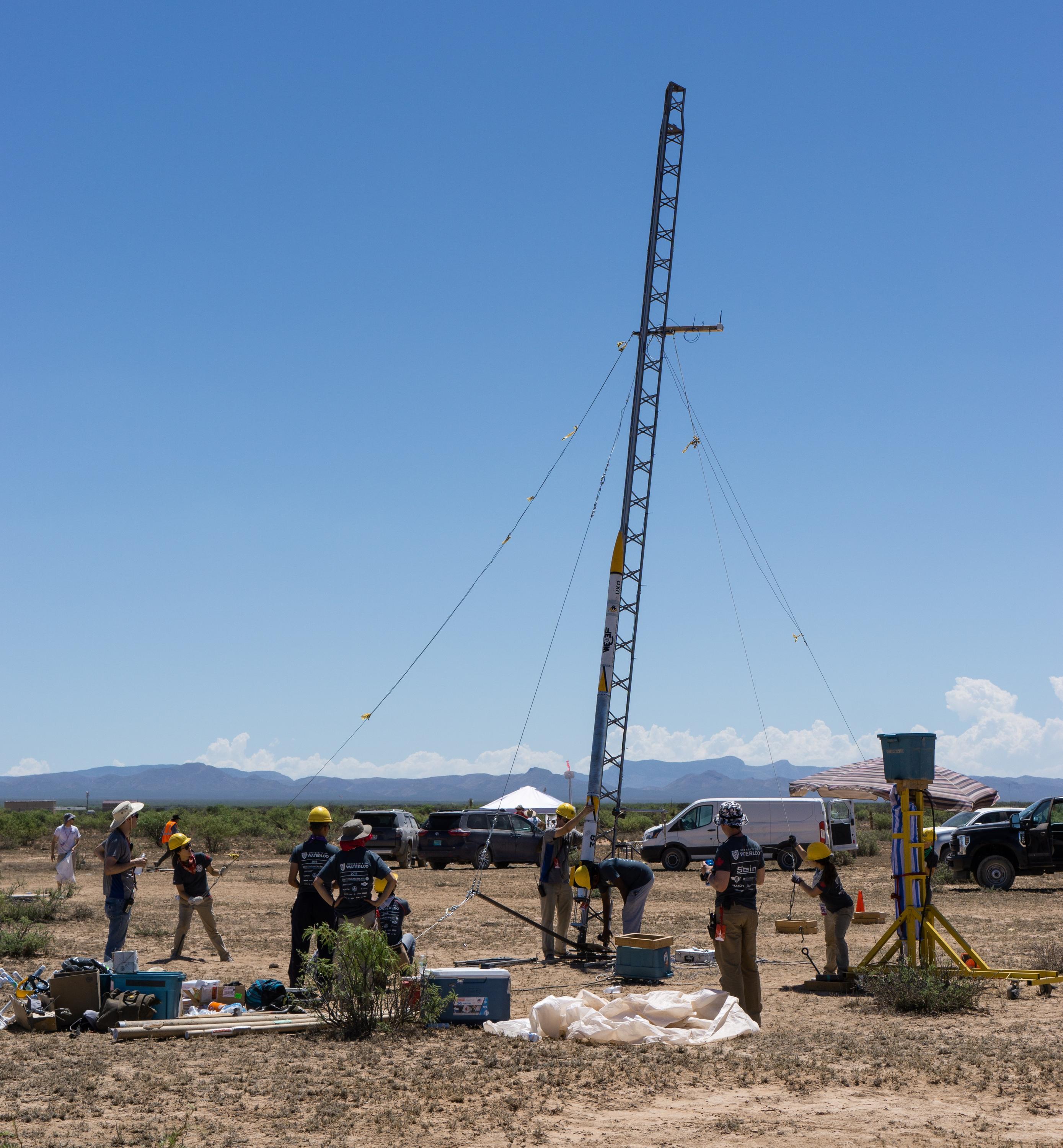 Members of a Waterloo Engineering student design team prepare to launch their new rocket, Unexploded Ordinance (UXO), during a recent competition in New Mexico, where they finished first in their category.
