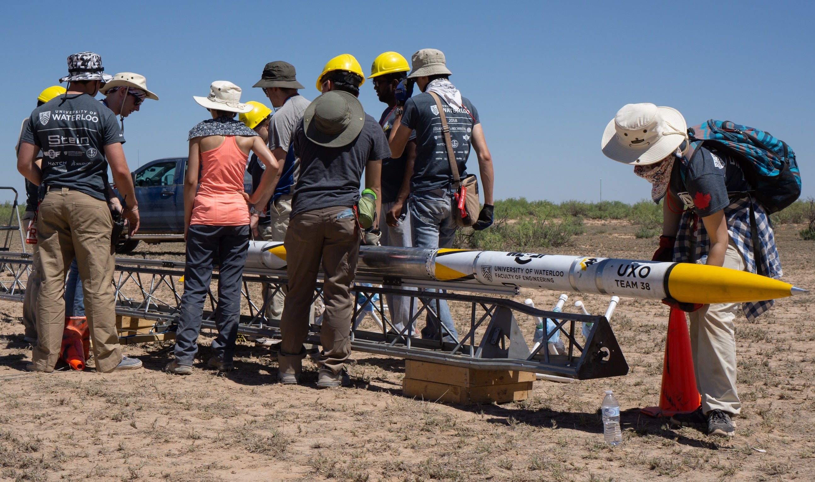 Members of a Waterloo Engineering student design team prepare to launch their new rocket, Unexploded Ordnance (UXO), during a recent competition in New Mexico, where they finished first in their category.