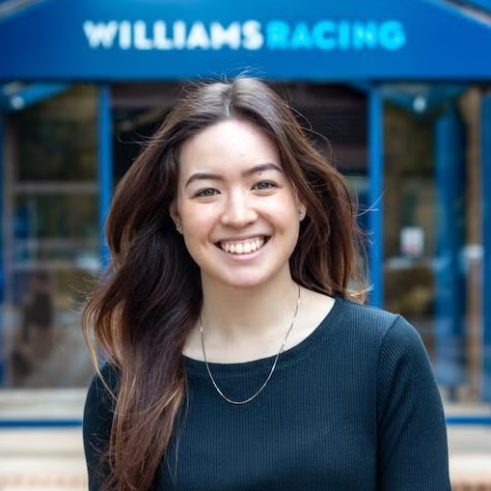Christina Sullivan standing in front of a sign that says "Williams Racing"