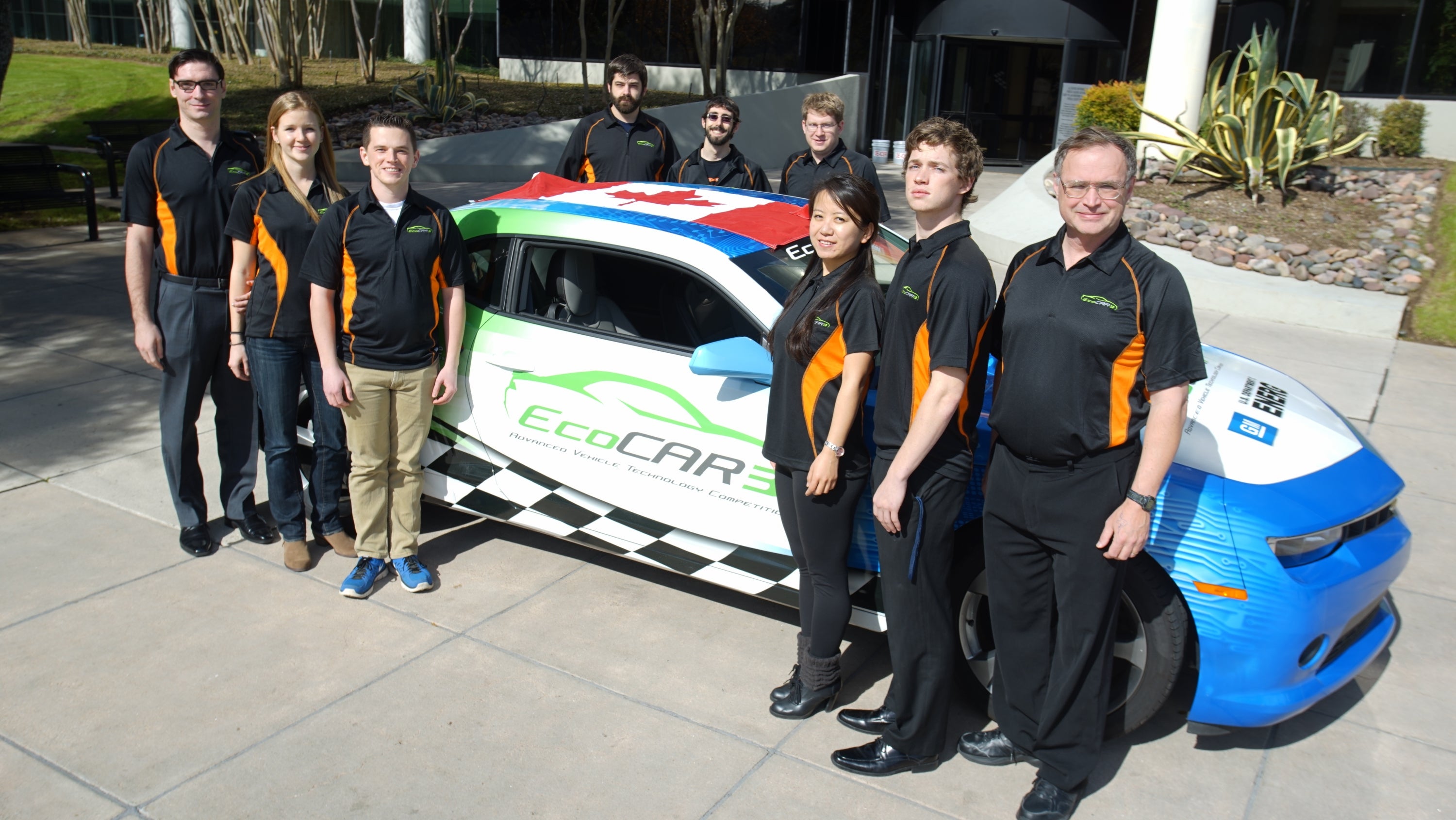 UWAFT team stands with Chevrolet Camaro EcoCAR 3 competition vehicle