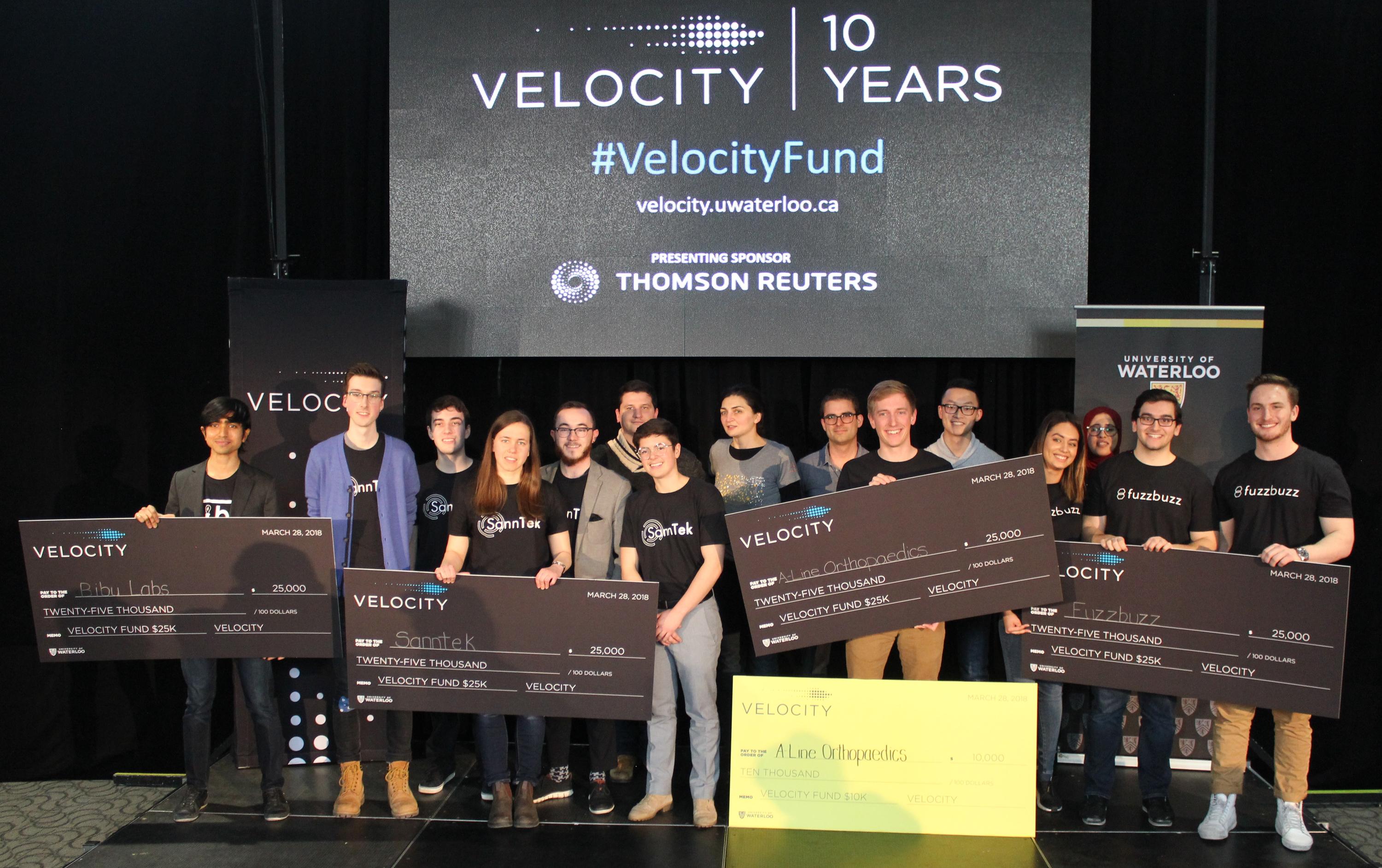 Winning startup companies pose with their prizes at the Velocity Fund Finals.