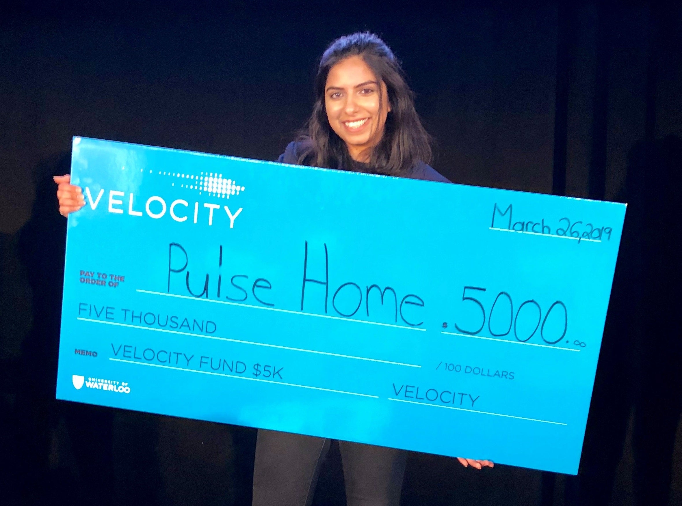 Emman Haider of Pulse Home poses with a ceremonial cheque at the recent Velocity Fund Finals.