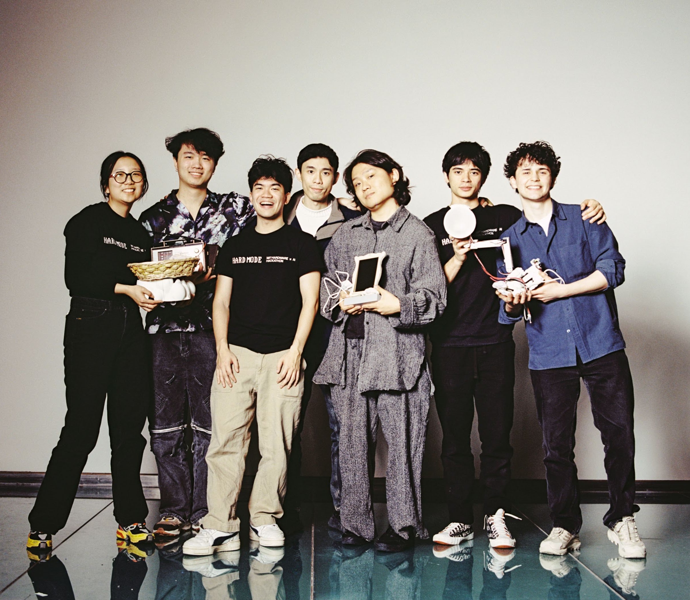 A group of students pose in front of a white background.