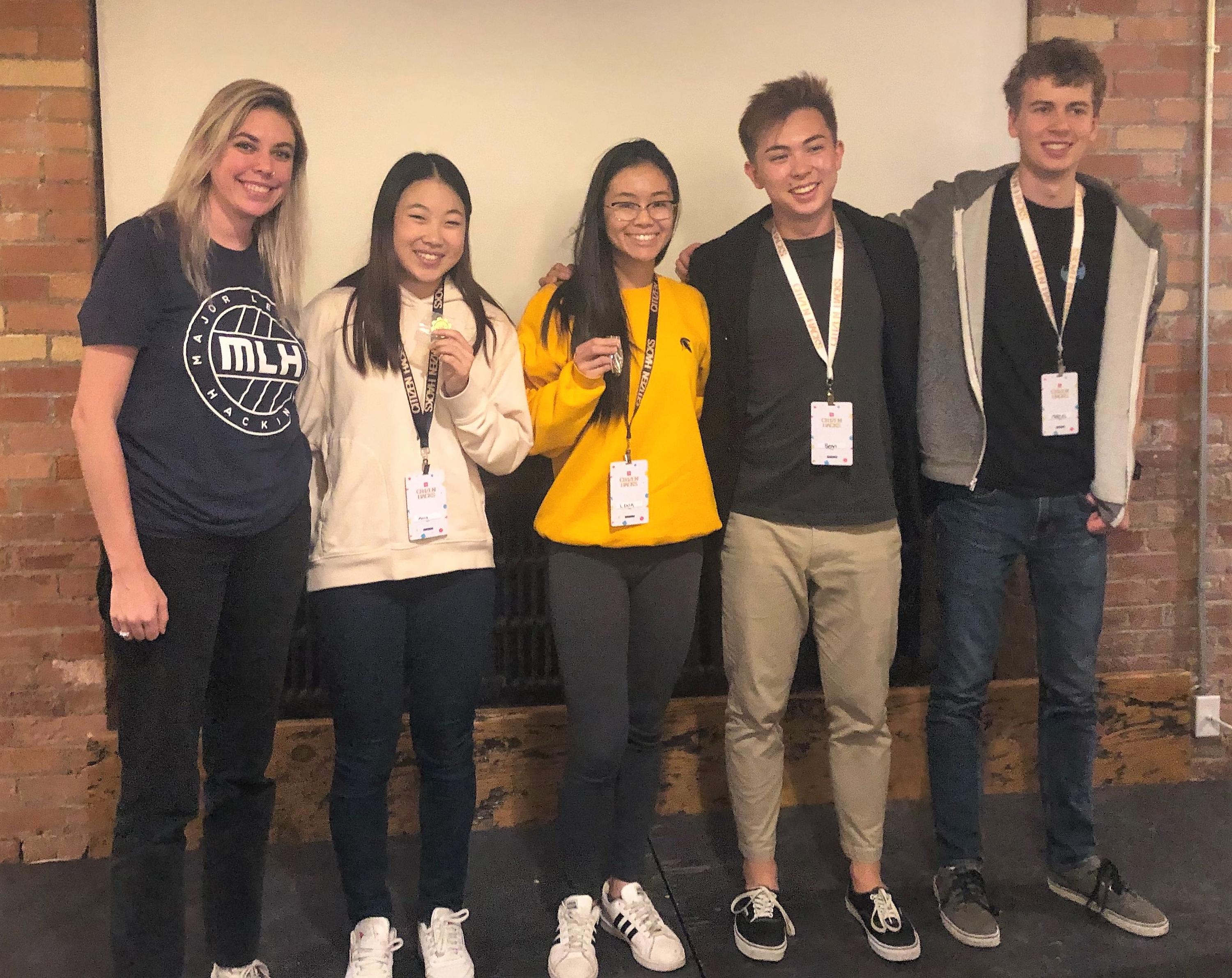 Anne Chung (secdond from left) and Lena Nguyen (third from left) pose with organizers after taking top place at the inaugural Citizen Hacks.