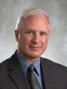 David Clausi, a white man with gray hair smiles at the camera.